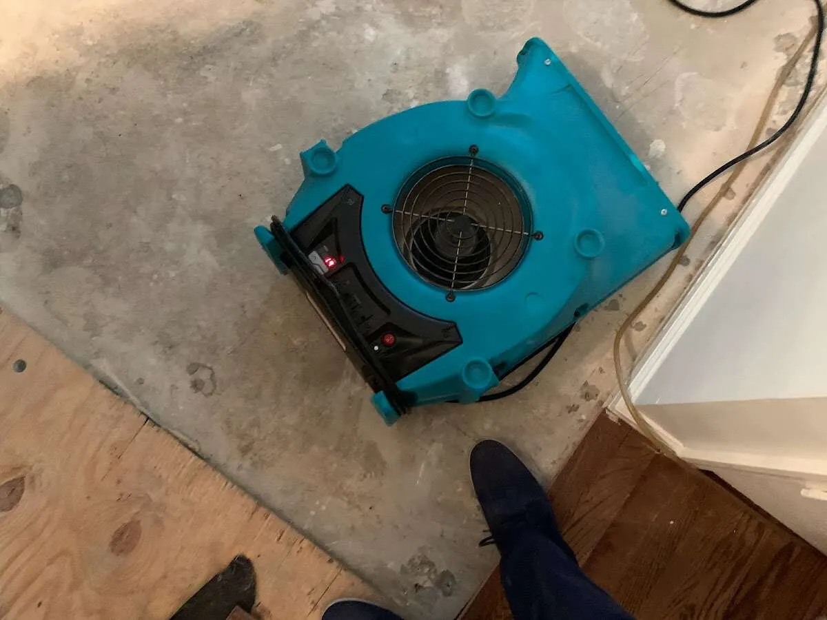 Air mover drying subfloor during Commercial Water Damage Restoration in Glenpool